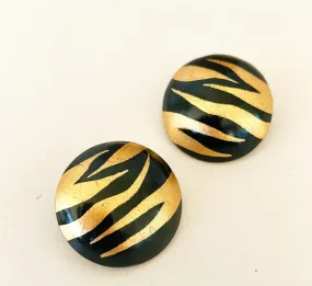 Large statement Joan collins style pierced earrings.